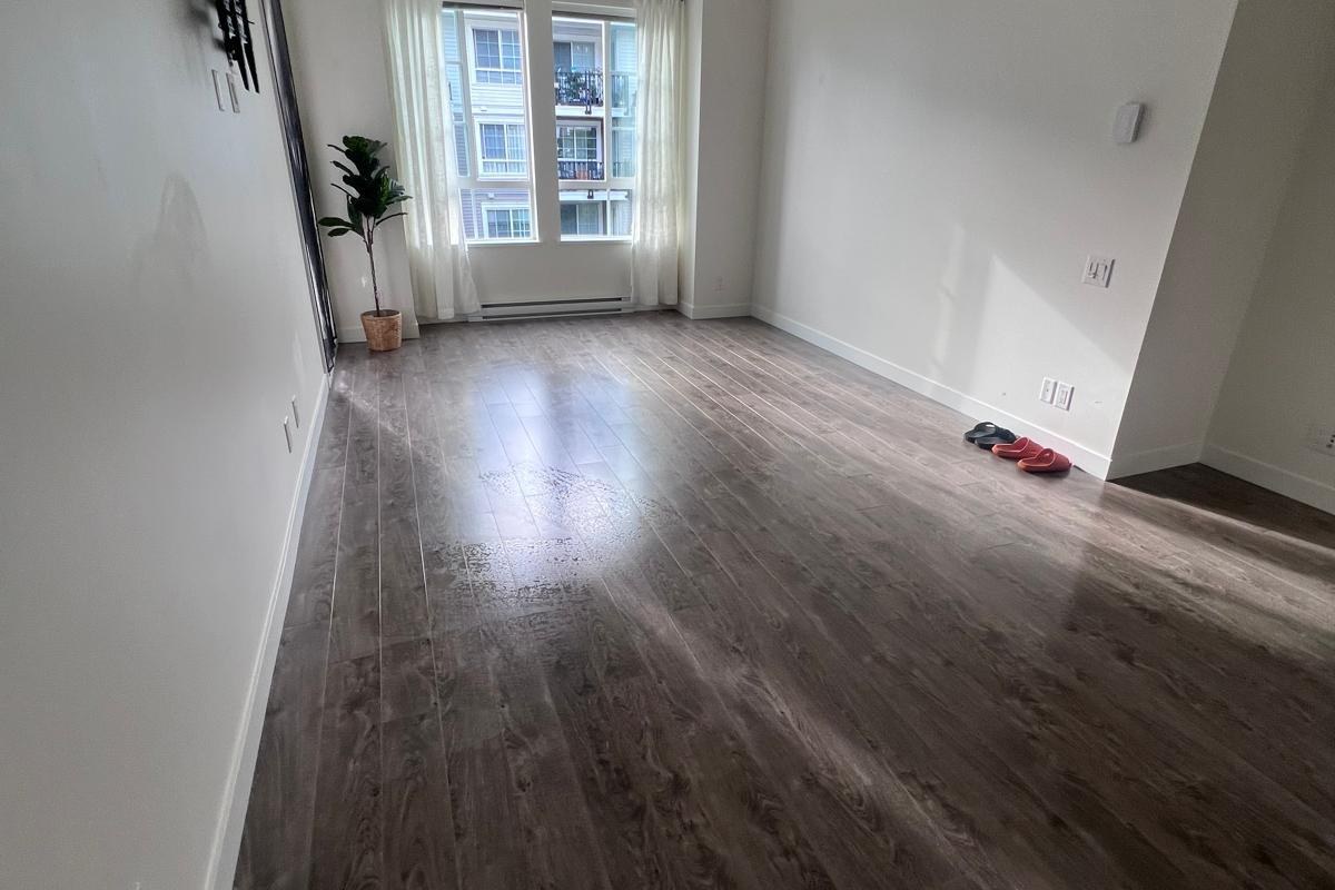Empty condo living room with hardwood floors cleaned in Vancouver BC
